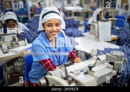 Ein Bekleidungsarbeiter arbeitet in einer Fabrik für fertige Bekleidung. Die Ready-Made-Garment-Industrie (RMG) ist ein Hauptpfeiler dieser wirtschaftlichen Erfolgsgeschichte. Stockfoto