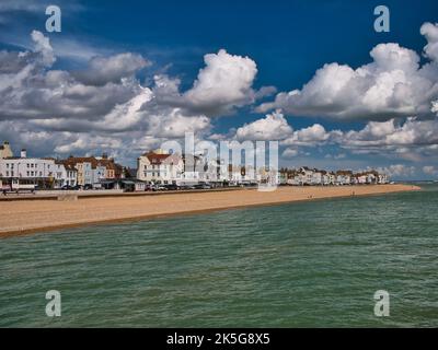 Die Kiesstrand- und Strandgebäude in Deal, Kent, England, Großbritannien. Aufgenommen vom Pier an einem sonnigen Tag im Sommer mit blauem Himmel und weißen Wolken. Stockfoto