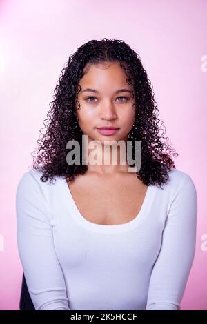 Headshot einer jungen schwarzen Schauspielerin auf einem rosa Hintergrund Stockfoto