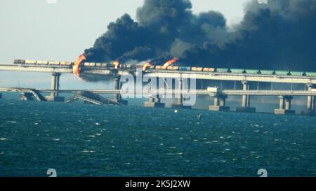 Krim, Russland. 08. Oktober 2022. Am Samstag, dem 8. Oktober 2022, explodierte in der Nähe von Kertsch ein Lastwagen, der bei einem Brand auf der Kertschbrücke, die die Krim mit Russland verbindet, schwarzen Rauch. Moskau gab bekannt, dass ein Lastwagen explodierte, der ein riesiges Feuer entzündete und die wichtige Kertsch-Brücke zerstörte, die als einzige Landverbindung Russlands mit der annektierten Krim errichtet wurde. Foto von Vladimir Mordunov/UPI. Kredit: UPI/Alamy Live Nachrichten Stockfoto