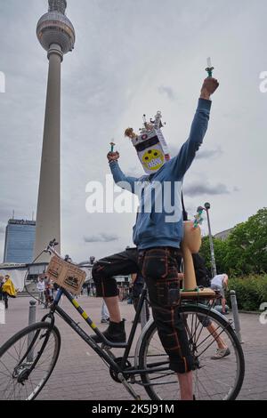 Deutschland, Berlin, 23. 05. 2020, Protest gegen Corona-Beschränkungen, Tanz zu Techno Music unter dem Fernsehturm, Mann mit Spritzen Stockfoto