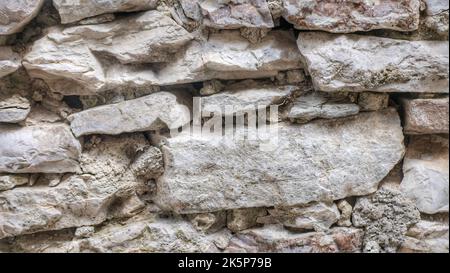 Textur einer Steinwand. Alte Burg Stein Wand Textur Hintergrund. Steinmauer als Hintergrund oder Textur. Teil einer Steinmauer, für Hintergrund oder Stockfoto
