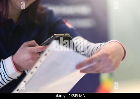 Das Konferenzpersonal scannt bei der Ankunft einen QR-Code des Teilnehmers zur Abferungsstelle Stockfoto
