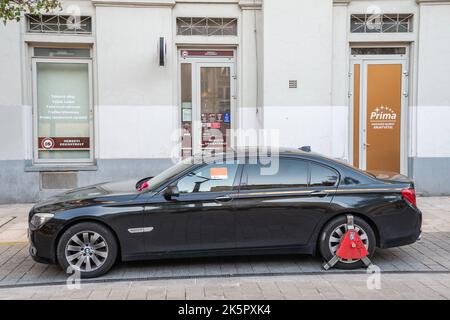 Budapest, Ungarn – 4. Oktober 2022. Auto mit einer Radklemme auf einer Budapester Straße. Das rote Schloss ist auf einem Rad angebracht, um sicherzustellen, dass das Parken nicht ordnungsgemäß erfolgt Stockfoto