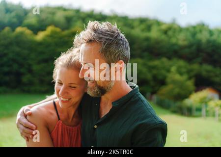 Nahaufnahme eines glücklichen Paares, das auf der Wiese im Freien von der Zukunft träumt. Stockfoto