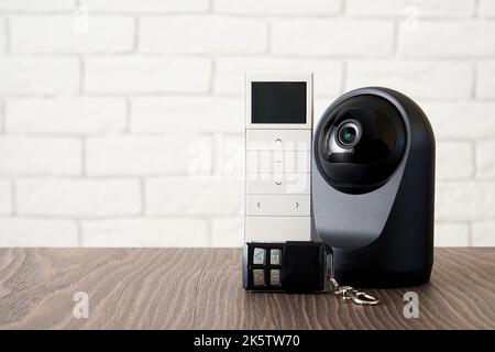 Sicherheits-IP-Kamera, Schlüssel und Wireless-Controller-Gerät für den Hauszugang. Smart-Home-Geräte und Datenschutz. CCTV Stockfoto