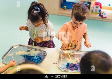 Kinder mit modernen Maltechniken im Kindergarten, Medium shot Kinderkonzept. Hochwertige Fotos Stockfoto
