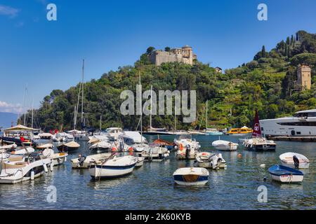 Portofino, Provinz Genua, Ligurien, Italienische Riviera, Italien. Das Gebäude auf dem Hügel im Hintergrund ist das Haus-Museum Castello Brown, oder Castle B Stockfoto