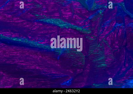 Ultravioletter Hintergrund knitterte Textur neon violett Stockfoto