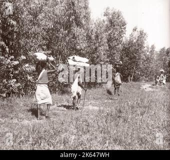 1940s Ostafrika - Uganda - Wanderarbeiter aus dem Kongo mit ihren Reisepaketen fotografieren einen während des Zweiten Weltkriegs in Ostafrika und im Nahen Osten stationierten britischen Rekrutierungsbeamten Stockfoto