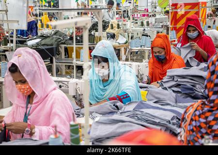 Gazipur, Dhaka, Bangladesch. 12. Oktober 2022. In einer Bekleidungsfabrik in Gazipur, Bangladesch, stellen Arbeiter Kleidung her. Vier von fünf der 4,4 Millionen Beschäftigten in der Bekleidungsindustrie in Bangladesch sind Frauen. Die Ready-Made-Garment-Industrie (RMG) ist ein Hauptpfeiler dieser wirtschaftlichen Erfolgsgeschichte. Bangladesch ist heute einer der größten Bekleidungsexporteure der Welt, wobei der RMG-Sektor 84 % der Exporte Bangladeschs ausmacht. Kredit: ZUMA Press, Inc./Alamy Live Nachrichten Stockfoto