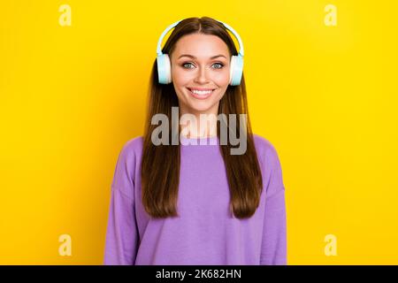 Foto von schönen niedlichen fröhlichen Dame strahlend Lächeln tragen violette Outfit Accessoire hören Lieblings-Track isoliert auf gelbem Hintergrund Stockfoto