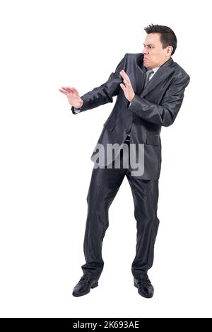 Angewiderter Mann in elegantem Anzug. Weißer Hintergrund. Stockfoto