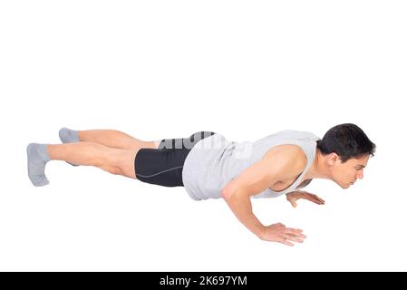 Serious Mann in activewear Durchführung Liegestütze Stockfoto