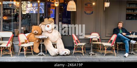 Während der Pandemie von Covid-19 halten zwei Riesenbären in einem Café in Paris, Frankreich, eine Männergesellschaft Stockfoto