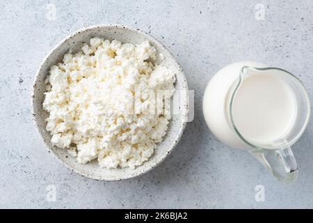 Hüttenkäse, Bauernkäse und Krug Kuhmilch. Milchprodukte, Draufsicht Stockfoto