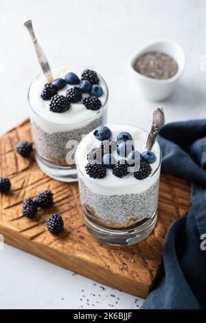 Veganer Joghurt Chia Pudding Mit Beeren Und Granola-Schicht Im Glas, Nahaufnahme Stockfoto