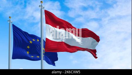 Detail der im Wind winkenden Nationalflagge Österreichs mit verschwommener eu-Flagge im Hintergrund an einem klaren Tag. Demokratie und Politik. E Stockfoto