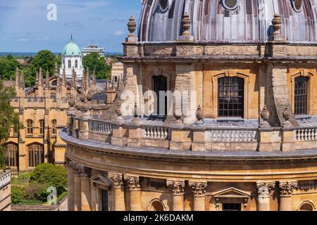 England, Oxfordshire, Oxford, Abschnitt der Kuppel der Radcliffe Camera, die ein Wahrzeichen von Oxford und eine funktionierende Bibliothek ist, Teil des zentralen Bodleian Library Complex, Hier vom Turm der Universitätskirche St. Maria die Jungfrau mit der grünen Kuppel des Sheldonian Theaters im Hintergrund gesehen. Stockfoto