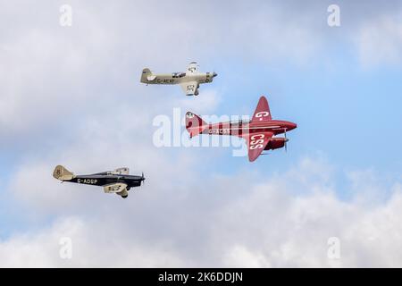 De Havilland DH.88 Comet, Percival Mew Gull & Miles Hawk Speed Six, in der Luft auf der Race Day Airshow, die am 2.. Oktober 2022 in Shuttleworth stattfand Stockfoto