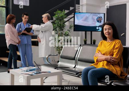 Porträt einer verletzten Frau, die auf einen Kontrollbesuch mit medizinischem Personal wartet und im Wartebereich des Krankenhauses sitzt. Senior Patient mit Krankheit Vorbereitung auf die Konsultation, mit einer Krankenversicherung Stockfoto