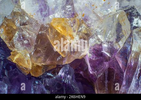 Ultra-Makro-Nahaufnahme eines natürlichen violetten Amethyst-Quarzanhäufens, isoliert auf schwarzem Hintergrund Stockfoto