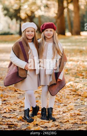 Glückliche Kinder kuscheln in einem schönen Herbstpark Stockfoto