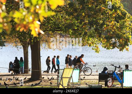 Herbstfarben und warmes Wetter durch das Serpentine im Hyde Park, in London, Großbritannien Stockfoto