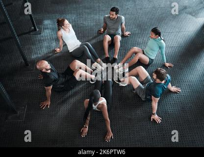 Es dauert nur eine Sitzung pro Tag. Eine Gruppe von Freunden, die während eines Trainings eine Pause einlegen. Stockfoto