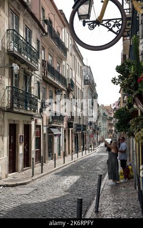 Frau zeigt auf alte Balkone in einer Straße in Bario Alto, Lissabon, Portugal Stockfoto