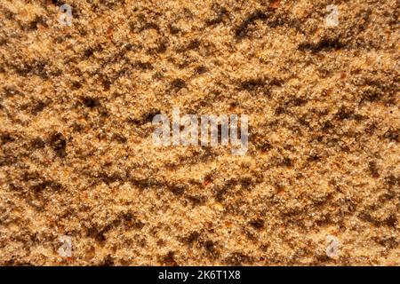 Schöne sandige hellbraune Hintergrund backen für Design. Nahaufnahme der Sandoberfläche Stockfoto