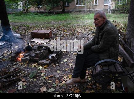 Bakhmut, Ukraine. 9. Oktober 2022. Yana, Bewohner von Bakhmut, sah, wie er vor seinem Gebäude eine Tasse Tee trank. Trotz der Vorrückung ukrainischer Truppen im Osten und Süden der Ukraine ist die Stadt Bakhmut im Osten von Donezk einem intensiven Widerstand ausgesetzt. Russland hat in der Stadt Gewinne erzielt. Die Stadt hat Tag und Nacht andauernden Beschuss erlebt und die Stadt ist derzeit ohne fließendes Wasser und Strom. (Bild: © Ashley Chan/SOPA Images via ZUMA Press Wire) Stockfoto