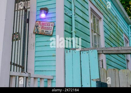 NEW ORLEANS, LA, USA - 13. OKTOBER 2022: Schild „Floozies and Hussies use side entrance“ vor dem Haus in Uptown Stockfoto