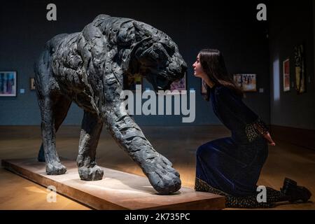 London, Großbritannien. 17. Oktober 2022. Ein Mitarbeiter blickt auf „Striding Tiger“, eine Bronze des südafrikanischen Künstlers Dylan Lewis (Est. £60.000 - £80.000), ‘einer Vorschau auf Bonhams Verkauf von moderner und zeitgenössischer afrikanischer Kunst, der am 19. Oktober in Bonhams Galerien in der New Bond Street stattfindet. Kredit: Stephen Chung / Alamy Live Nachrichten Stockfoto