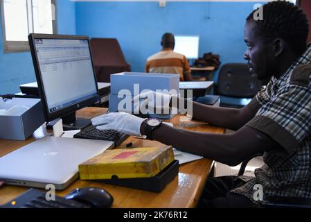 Moussa Kalapo, Fotograf des Photographic Training Center von Bamako, ist für das Archivierungsprojekt beschäftigt und füllt dann eine Excel-Tabelle mit allen Informationen aus, die die Fotografie zur Verfügung stellen kann. (Sammlung, Name des Fotografen, Jahr, Beschreibung, Format, ect ..) Stockfoto