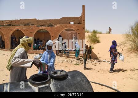 Dorfbewohner aus Koygouma (Kreis Goundam, Gemeinde Gargando) in der Region Timbuktu kommen, um Wasser aus einer Zisterne zu holen. Nach Angaben einiger Bewohner würden die Tanks in Goundam etwa 50km von Koygouma aus gefüllt werden, bevor sie in das Dorf transportiert werden. Der Zugang zu Trinkwasser ist heute eines der wichtigsten Probleme für die Bevölkerung dieser Wüstengebiete, die mit einer erheblichen Wasserknappheit konfrontiert sind, während im vergangenen April 2086 malische Flüchtlinge aus dem Mbera-Lager in Mauretanien in ihr Dorf zurückgeführt wurden. Stockfoto