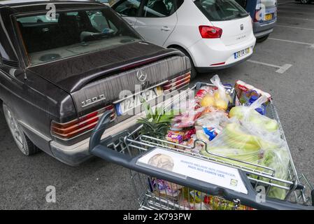 Hier in Albufeira an der Algarve beginnen sich die Leute vor einem Lidl-Laden anzustellen, der einen Hausmeister eingerichtet hat und nur wenige Kunden auf einmal einlässt. Stockfoto