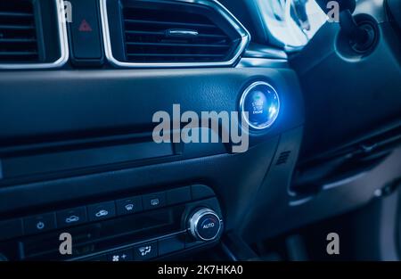 Start STOP Motor Taste des Luxusautos. Taste zum Starten oder Stoppen des Motors im schlüssellosen Fahrzeug drücken. Zündschlüssel mit Zündsystem drehen. Stockfoto