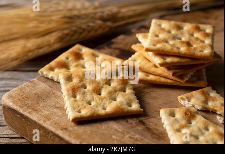 Cracker vor altem Holzhintergrund platziert. Nahaufnahme. Stockfoto