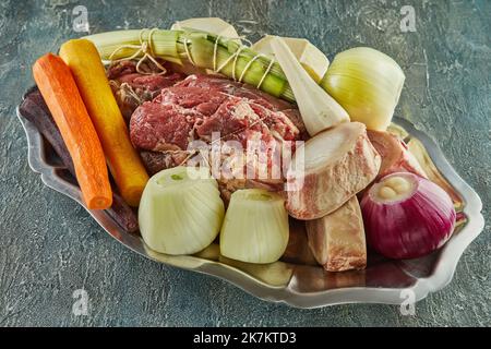 Stück frisches Rindfleisch mit Karotten, Zwiebeln und Knoblauch Stockfoto