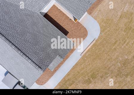 Beim Bau von neu gebauten Haus Dach wird mit Asphalt Schindeln als Haus gebaut Platz bedeckt Stockfoto