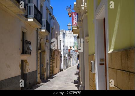 Ein Blick auf die Via Cavour, eine typische schmale, gepflasterte Straße in der Altstadt von Galatina, Apulien (Apulien), Italien. Stockfoto