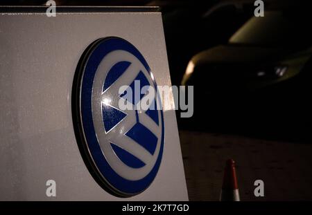 Leipzig, Deutschland. 19. Oktober 2022. Das demontierte alte VW-Logo liegt auf einem Parkplatz mit Neu- und Gebrauchtwagen eines Volkswagen-Autohauses in Leipzig. Volkswagen hatte sein Markenlogo leicht modifiziert. Das bisherige Logo wird schrittweise ersetzt. Quelle: Hendrik Schmidt/dpa/Alamy Live News Stockfoto