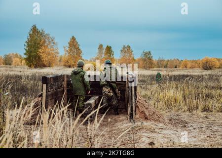 Tatarstan, Russland. 10. Oktober 2022. Mobilisierte russische Soldaten werden auf dem Trainingsgelände einer Kampfausbildung unterzogen. Zwei Soldaten stehen hinter einem Zaun Stockfoto