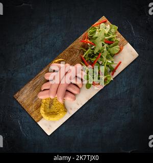 Wiener serviert mit Senf und grünem Salat, Restaurant Frühstückskonzept Stockfoto