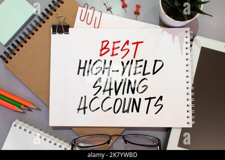 Business und Finanzen. Auf den blauen Finanzcharts ist ein Stück Karton mit der Aussage „Best High-Yield Saving Accounts“ zu sehen Stockfoto