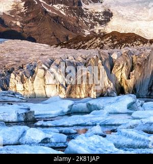 Warmes Sonnenlicht über das Eis und die Berge des Svinafellsjokul Gletschers bei Sonnenuntergang., südisland. Detail des größeren Vatnajokull-Gletschers, der Large Stockfoto