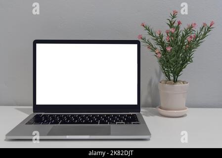 Computer-Laptop-Modell mit leerem Bildschirm auf dem Schreibtisch.modernes Technologiekonzept. Stockfoto