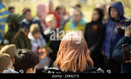 Mädchen bei der Trauerfeier in Russland. Menschen am Grab des unbekannten Soldaten. Details des denkwürdigen Tages. Stockfoto