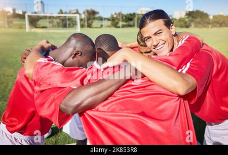 Fußball, Fitness und Team in einem Gespann für Motivation, Ziele und Gruppenmission auf einem Fußballplatz für ein Sportspiel. Lächeln, Teambildung und Fußball Stockfoto